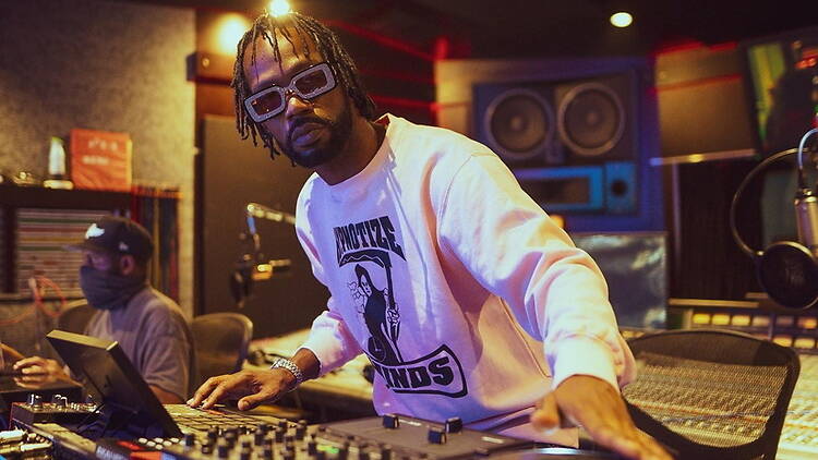 Close-up of a music producer adjusting a mixing console in a recording studio. Close-up of a music producer adjusting a mixing console in a recording studio.