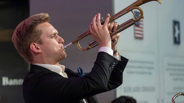 Close-up of musician playing a trumpet onstage. Close-up of musician playing a trumpet onstage.