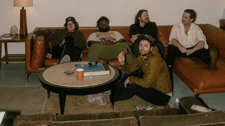 A wide shot of a band sitting together in a lounge. A wide shot of a band sitting together in a lounge.