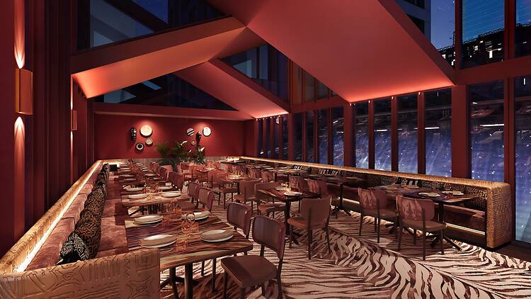 Interiors of The Meat & Wine Co lit up, printed carpet, seating