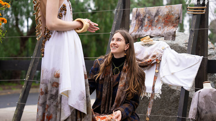 RMIT Open Day Makers Market A woman helping another with a dress at a market stall