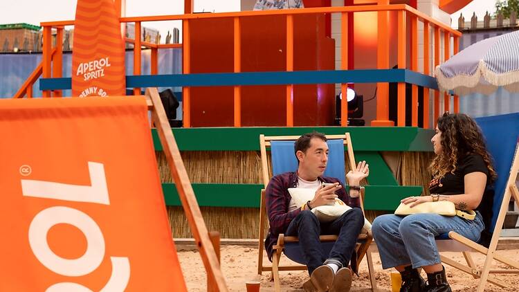 Big Penny Beach Club Visitors recline on deckchairs at Big Penny Beach Club