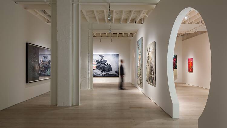 person looks at art work in gallery
