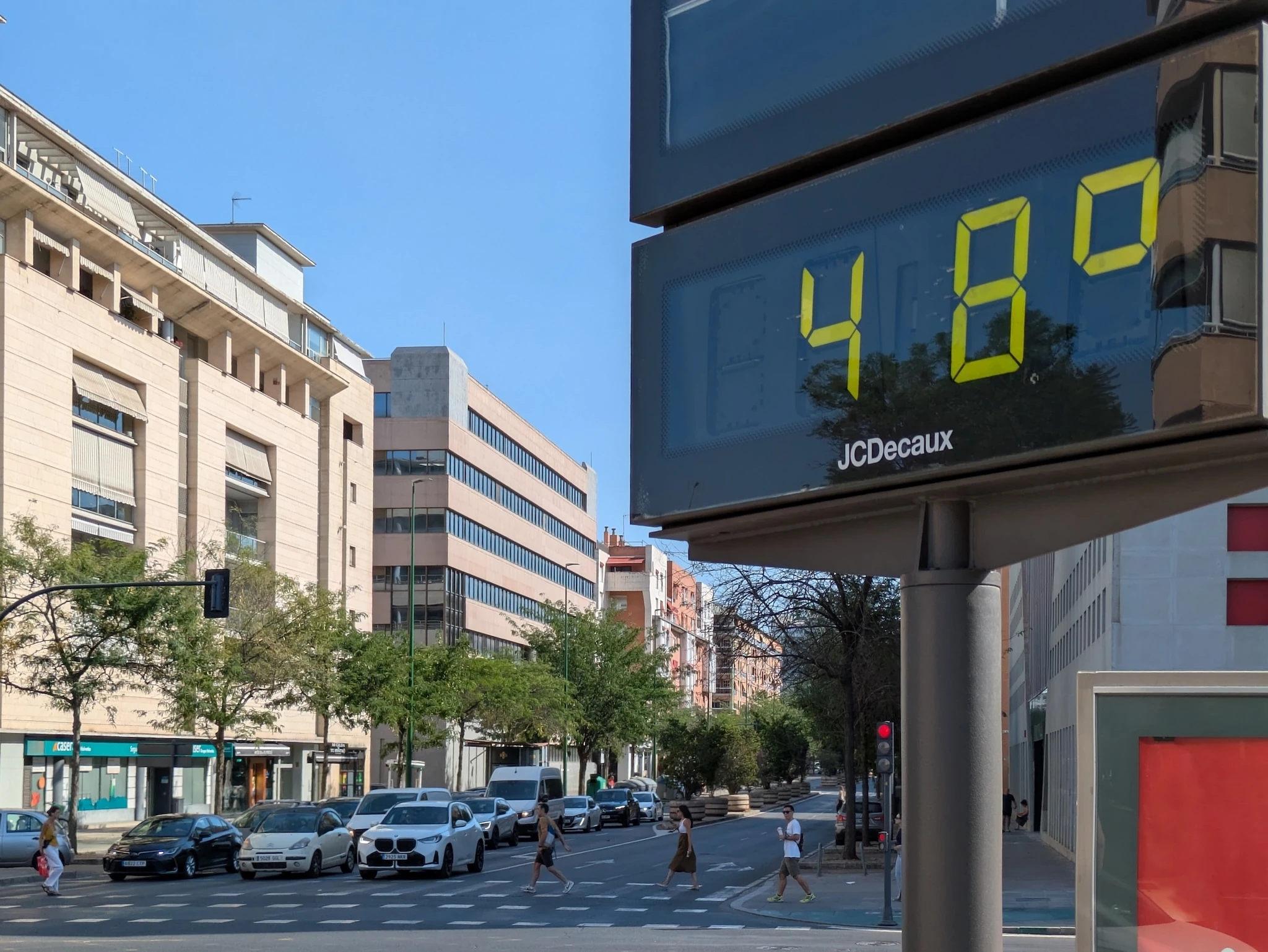 Public street thermometer on Avenida de la Buhaira, Seville, displays 48C during an intense summer heatwave