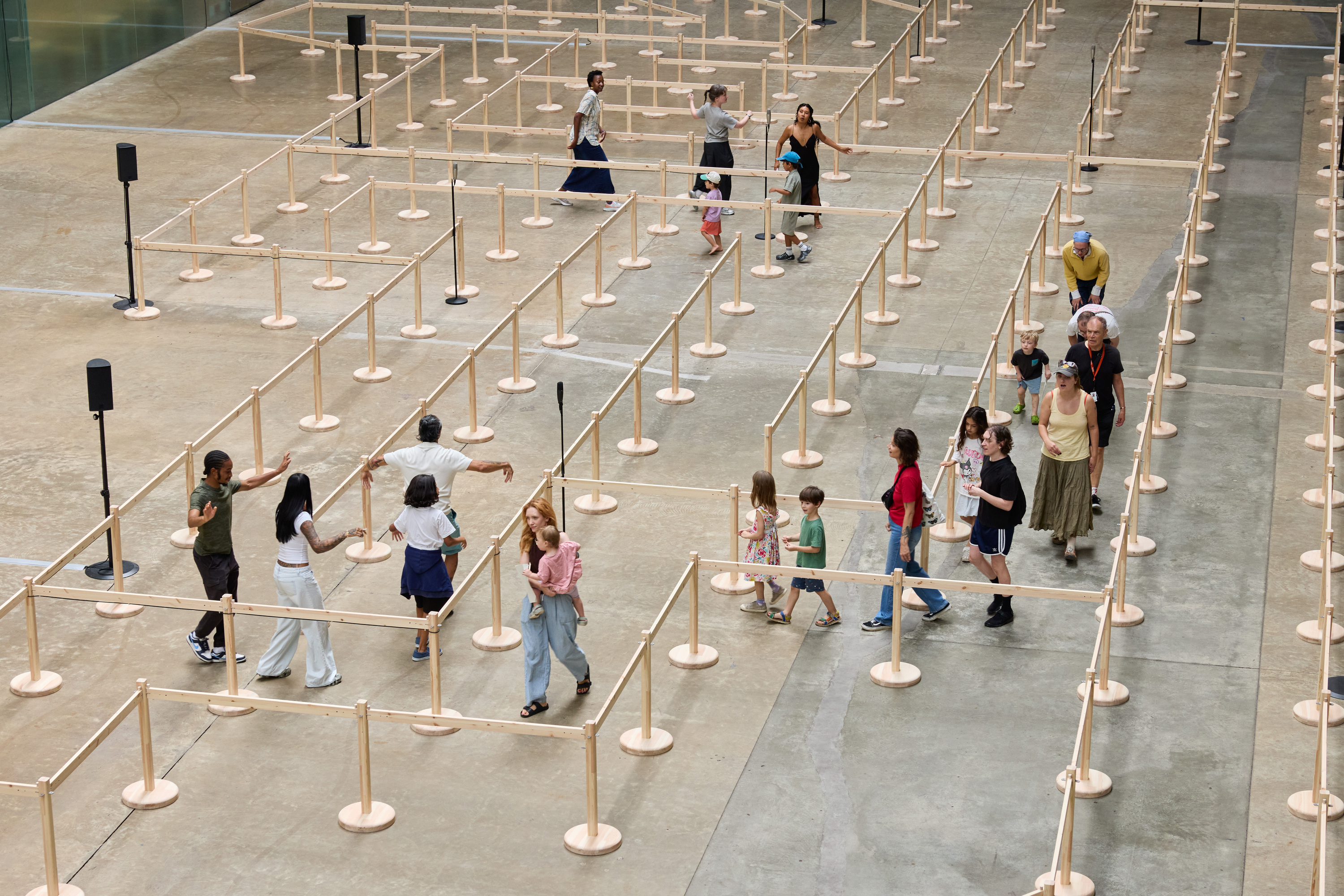 People walking through the wooden barrier maze