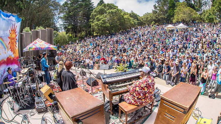 Wide view of band performing before a large outdoor audience Wide view of band performing before a large outdoor audience