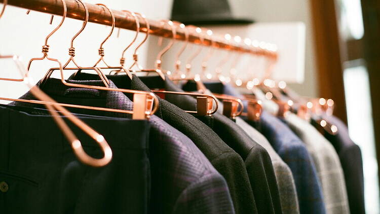 Close-up of clothing hanging on a rack in a retail store. Close-up of clothing hanging on a rack in a retail store.