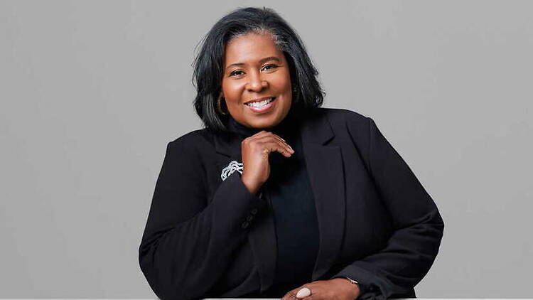 Close-up of person smiling for a portrait against a gray background. Close-up of person smiling for a portrait against a gray background.