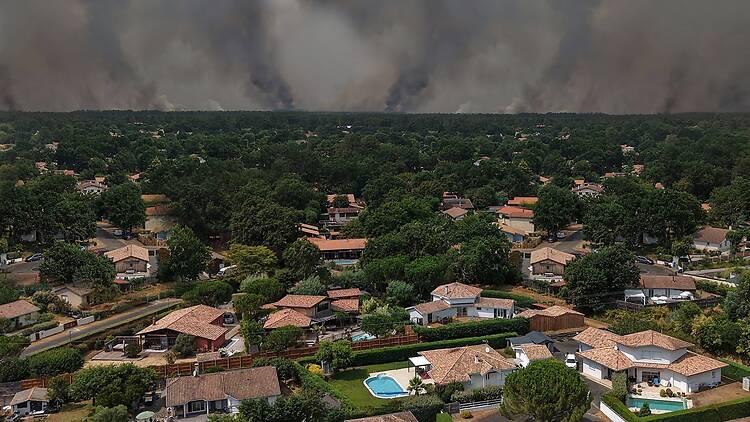 Lege Cap Ferret, Gironde, France - A drone view of a wildfire burning in a forest area near the Bassin dArcachon amid drought conditions. Lege Cap Ferret, Gironde, France - A drone view of a wildfire burning in a forest area near the Bassin dArcachon amid drought conditions.