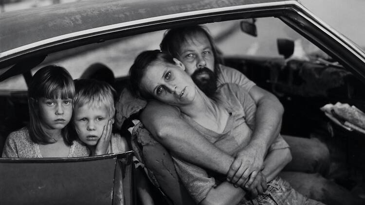 Black and white portrait of a family sitting in their car Black and white portrait of a family sitting in their car