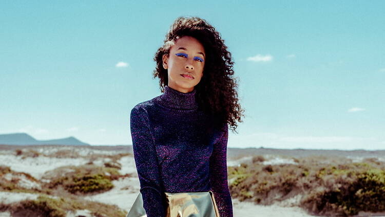A person standing in a desert landscape A person standing in a desert landscape
