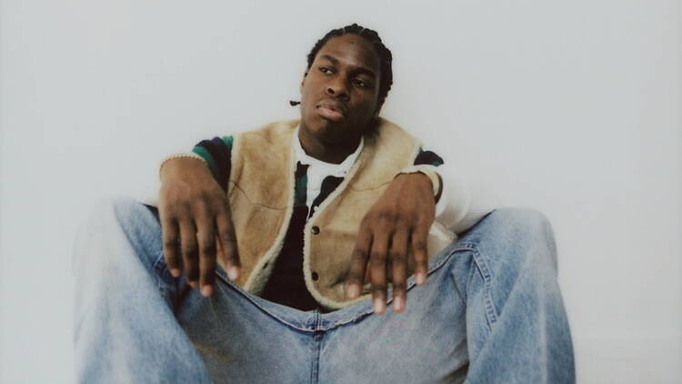 A person sitting against a plain background