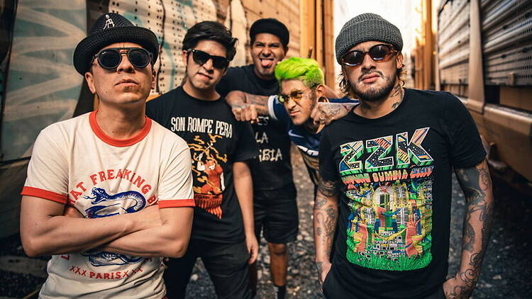 A group of people posing together in an alleyway A group of people posing together in an alleyway
