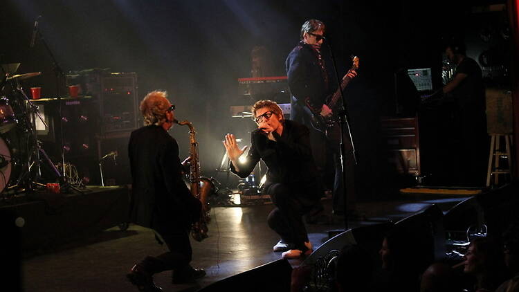 A wide shot of a band performing on a stage A wide shot of a band performing on a stage