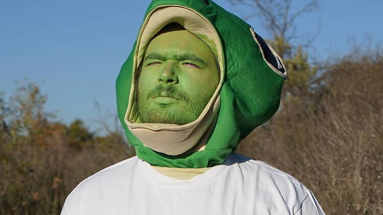 A person wearing a green costume outdoors A person wearing a green costume outdoors