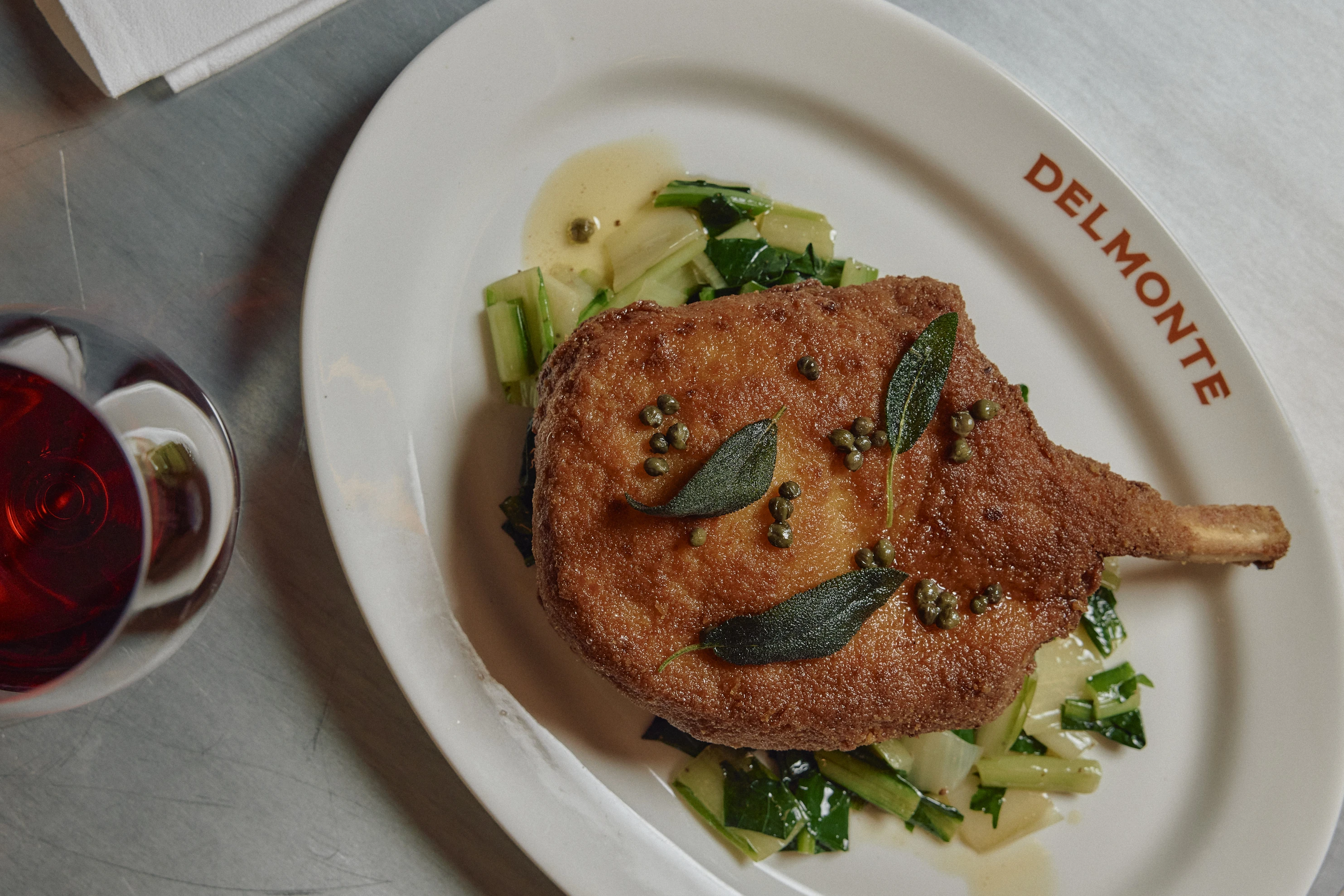 A crumbed pork cutlet on a plate.
