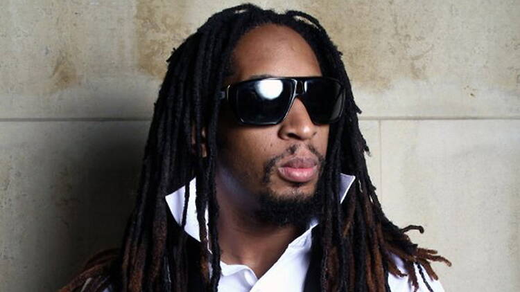 A close-up of a person wearing sunglasses against a concrete wall. A close-up of a person wearing sunglasses against a concrete wall.
