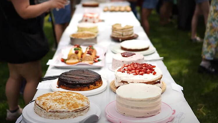Close-up of cakes displayed on a dessert table at an outdoor gathering. Close-up of cakes displayed on a dessert table at an outdoor gathering.