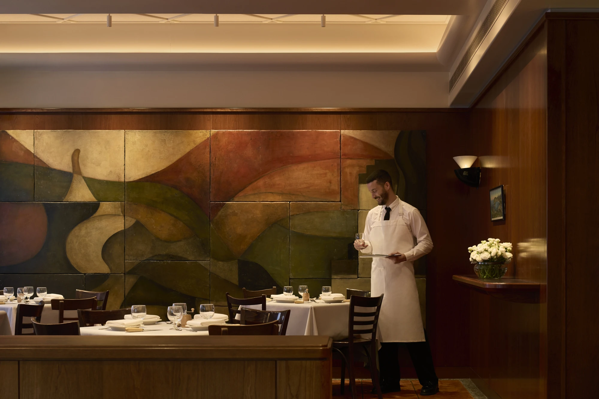 A waiter setting tables at C&ocirc;te Basque.
