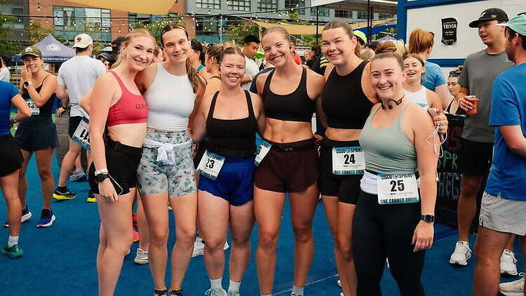 A wide shot of runners posing before a race.