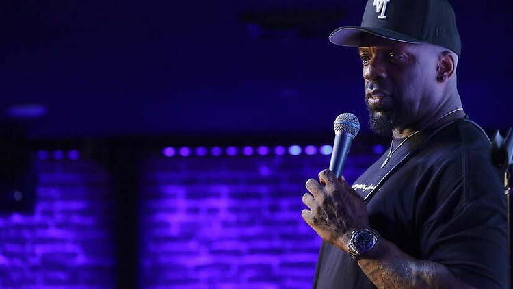 A close-up of a comedian performing on a stage.