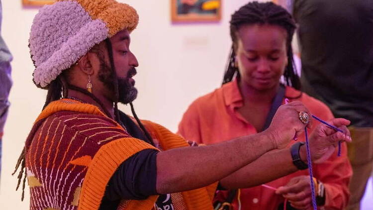 Close-up of a person demonstrating rope art at an indoor workshop. Close-up of a person demonstrating rope art at an indoor workshop.
