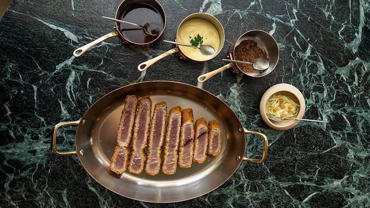 The tuna schnitzel, served as a sharing plate with pomme purée, fish jus, sherry onions and mustard coleslaw