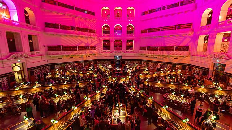 Library Up Late People in the State Library Victoria lit up in pink light.