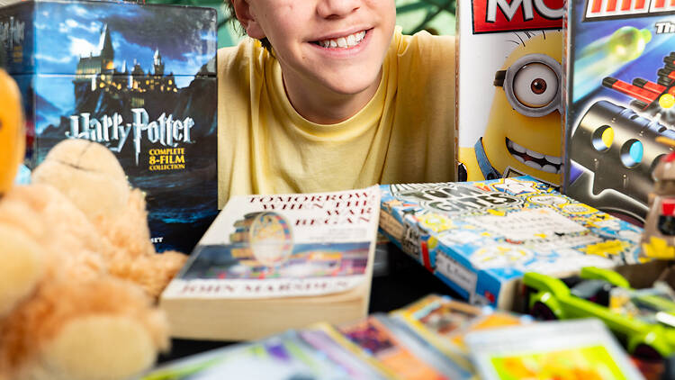 RESET Festival Boy holds board games.