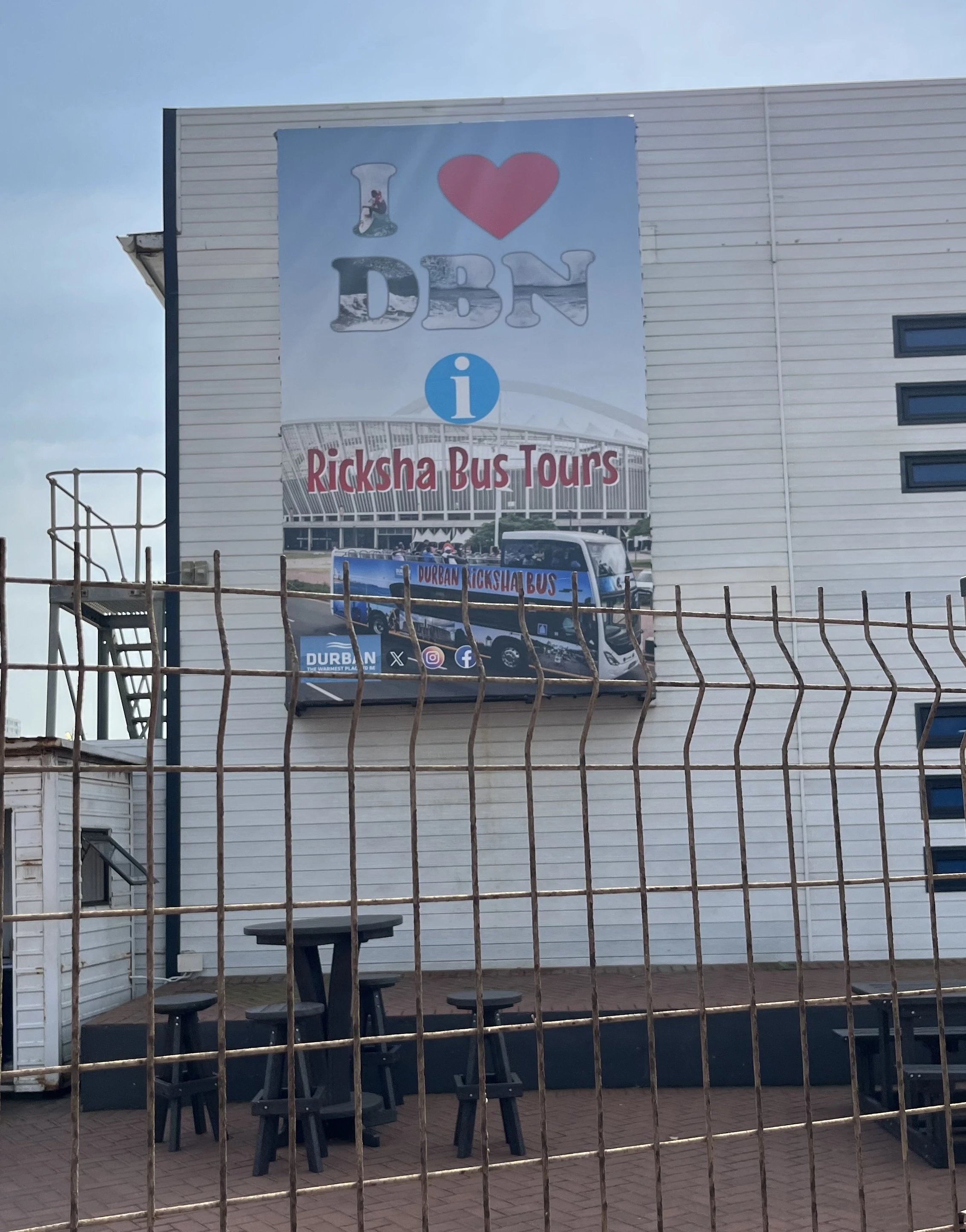 Ricksha Bus Tours sign promoting Durban city tours.