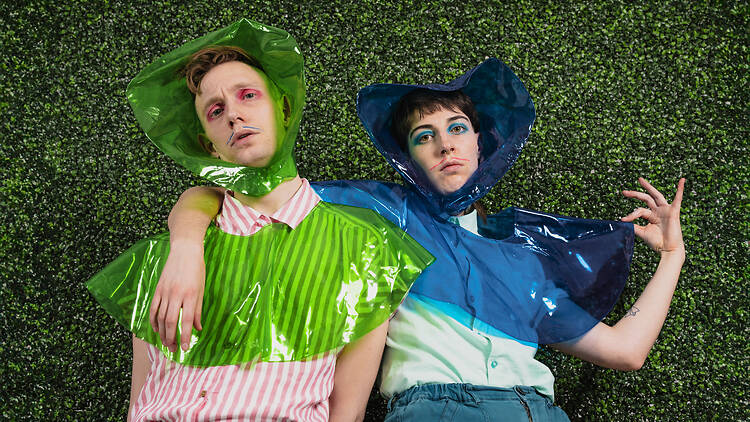 Melbourne Fringe Festival Two people standing against a hedge.