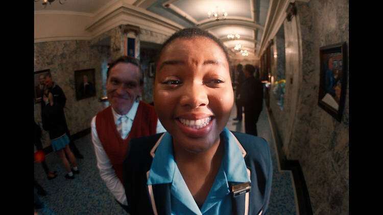 Luthando smiles at the camera in a school corridor in Black Burns Fast. Luthando smiles at the camera in a school corridor in Black Burns Fast.