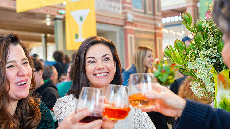 The Little Food Market three women say cheers by clinking glasses