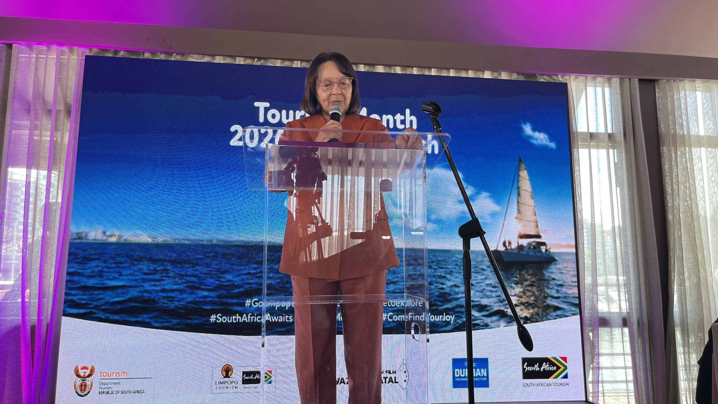 Tourism Minister Patricia de Lille speaking at a podium during the Tourism Month launch in Durban.
