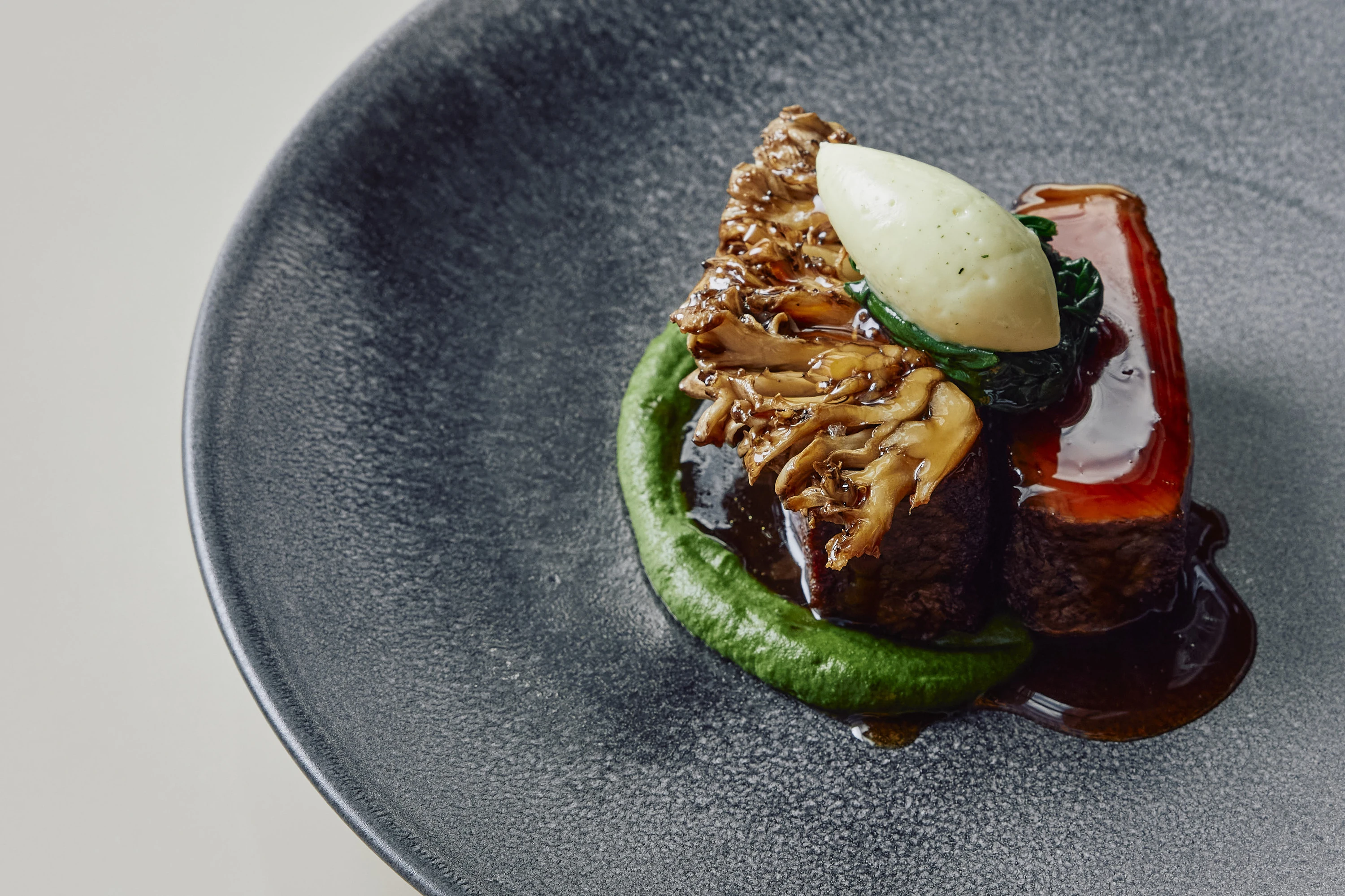 A plate of pure-bred black Angus beef with parsley, kombu, horseradish and maitake mushrooms at Bennelong restaurant.