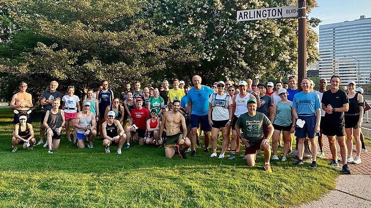 A wide shot of a group poses together outdoors near Arlington Boulevard. A wide shot of a group poses together outdoors near Arlington Boulevard.