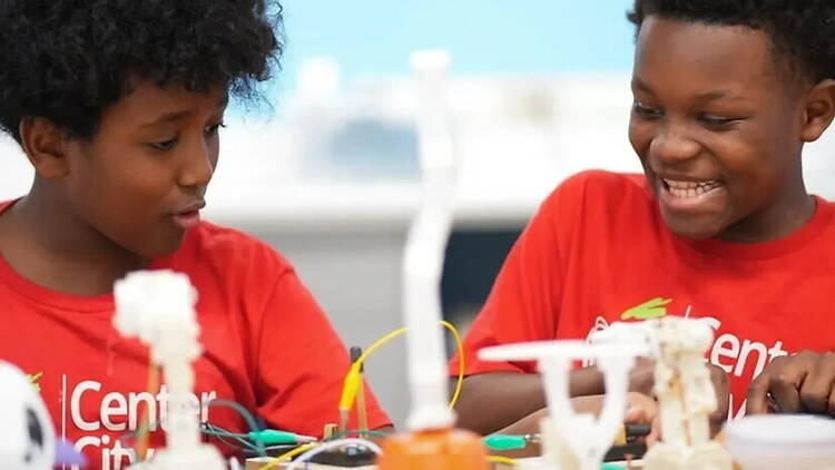 A close-up of two children building a project during a STEM activity. A close-up of two children building a project during a STEM activity.