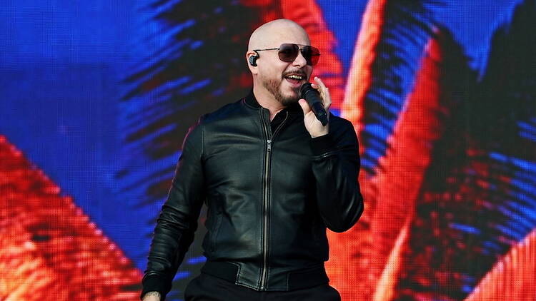 A close-up of a singer performing onstage with a microphone. A close-up of a singer performing onstage with a microphone.