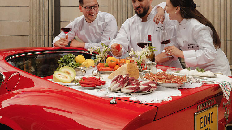 Big Mamma Group founders eating Italian fare on a car boot