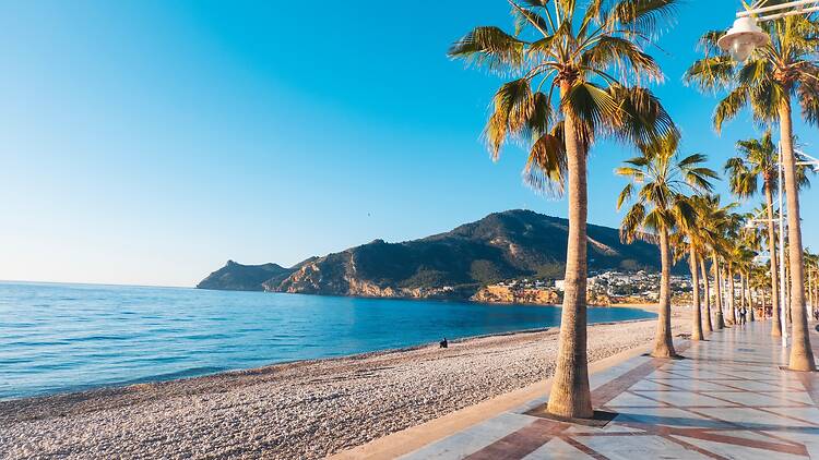 View to beautiful Albir town with main boulevard promenade, seaside beach and Mediterranean sea. Albir is small resort city between Altea and Benidorm, Alicante province, Spain View to beautiful Albir town with main boulevard promenade, seaside beach and Mediterranean sea. Albir is small resort city between Altea and Benidorm, Alicante province, Spain