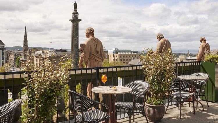 Lamplighter rooftop bar at Gleneagles Townhouse, showing statues, chair and tables and views
