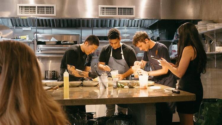 Rusty Supper Club Brandon Siu, Greg Preston, and Matt Greene cooking in a kitchen