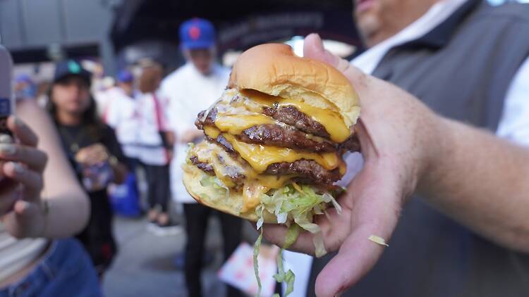 Citi Field A person holding a quadruple patty
