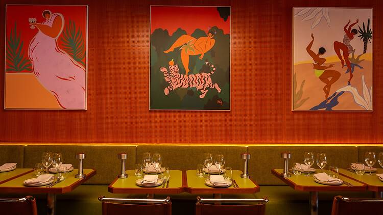 Dining tables and colourful art at Tyga.