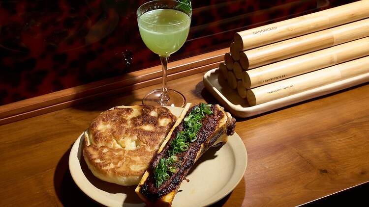 A plate of food and a cocktail.
