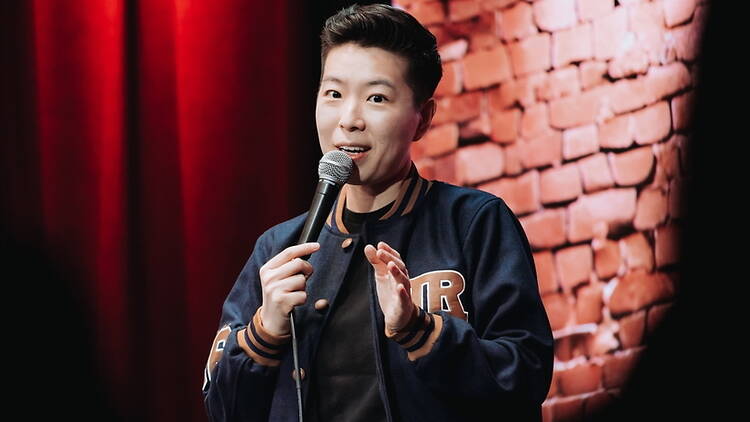 Close-up of a comedian speaking into a microphone on a stage Close-up of a comedian speaking into a microphone on a stage