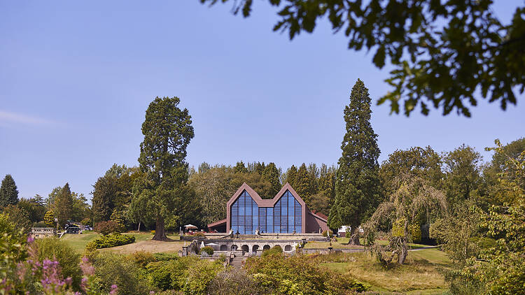 The Plumicorn restaurant : The modern glass-fronted building with its distinctive twin-peaked roof sits centrally on the hill.