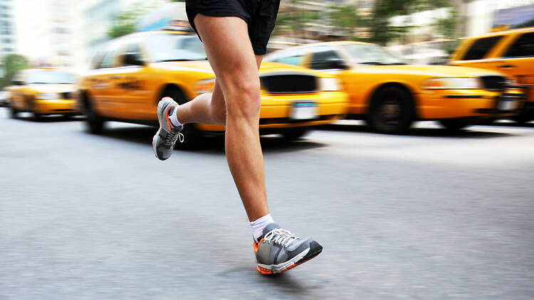 Jogger running amidst NYC taxicabs Jogger running amidst NYC taxicabs
