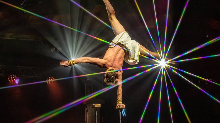 GODZ A performer balances on one hand during GODZ