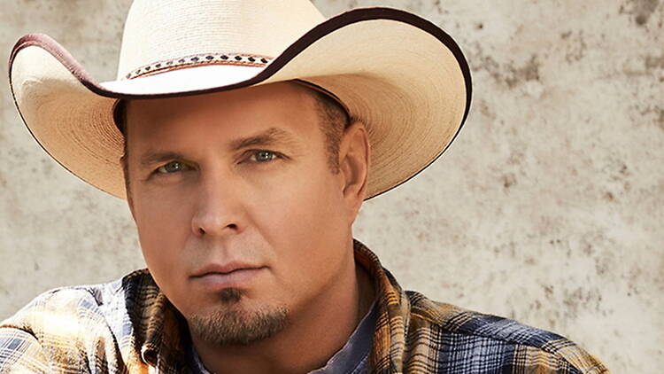 A close-up of a person wearing a cowboy hat against a textured backdrop. A close-up of a person wearing a cowboy hat against a textured backdrop.